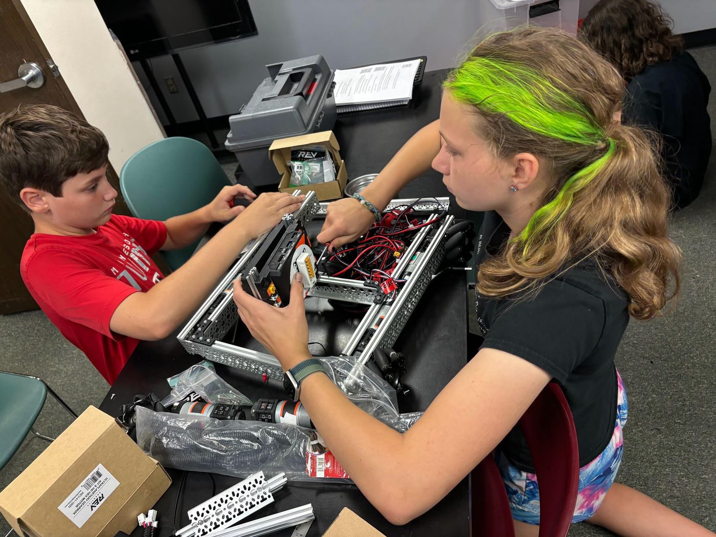 Students building a robot together during the summer program
